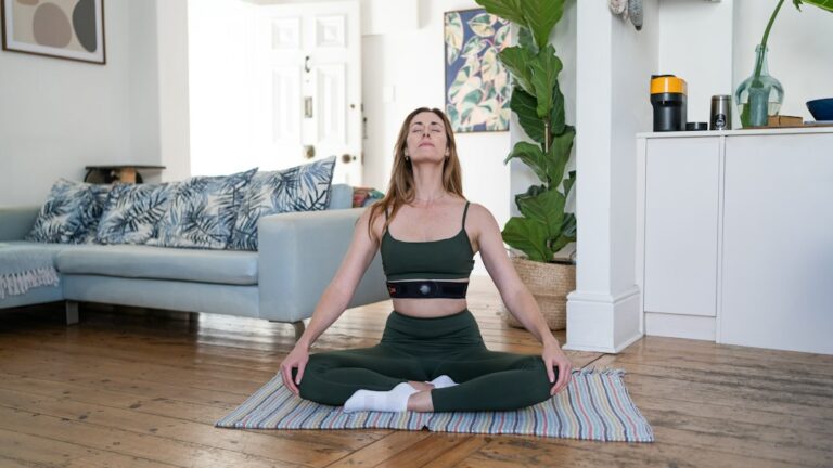 Person seated indoors with both feet on the floor, calmly naming nearby objects during an anxiety exercise.